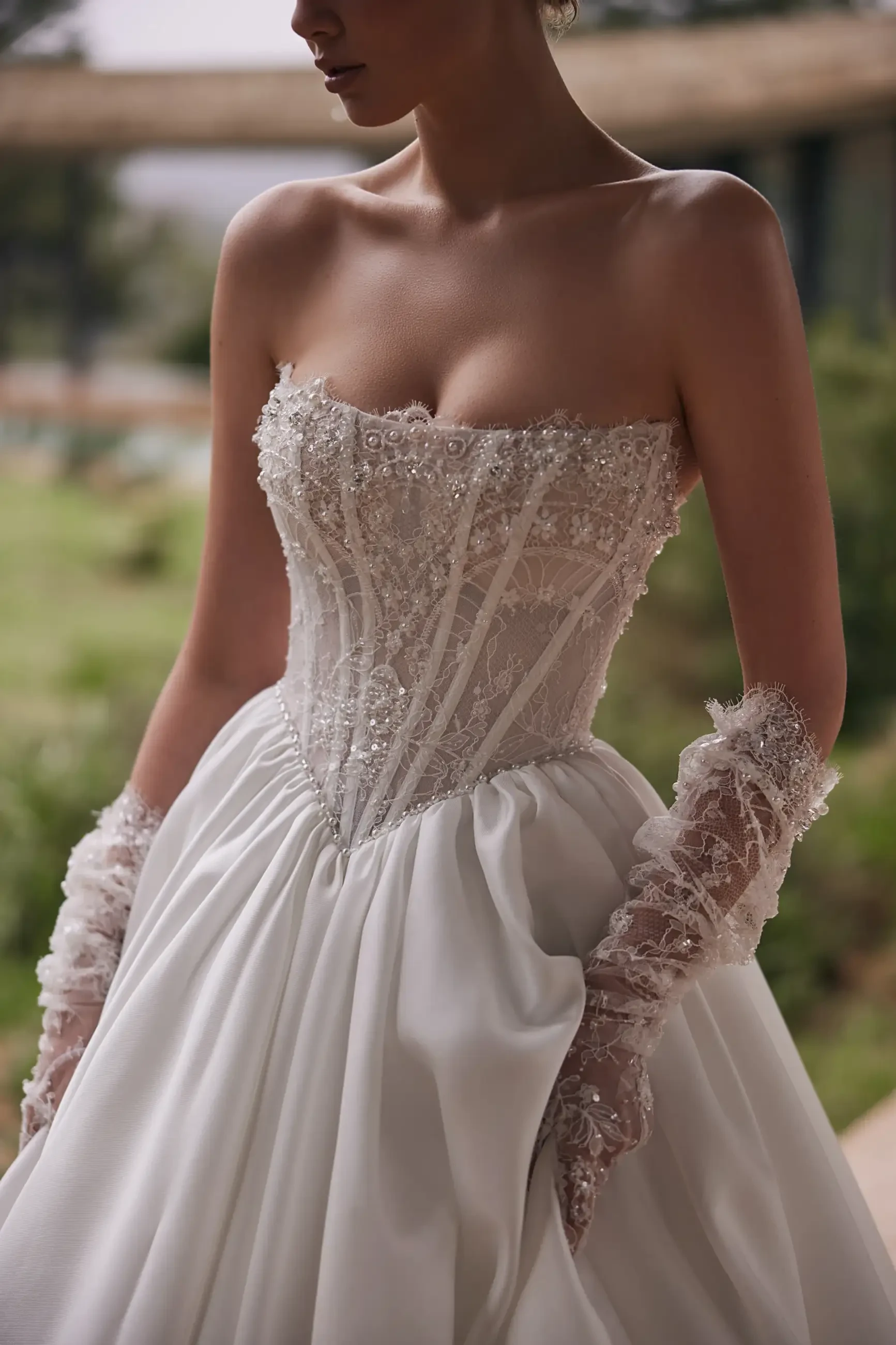 Model is wearing an a-line strapless straight neckline wedding gown 