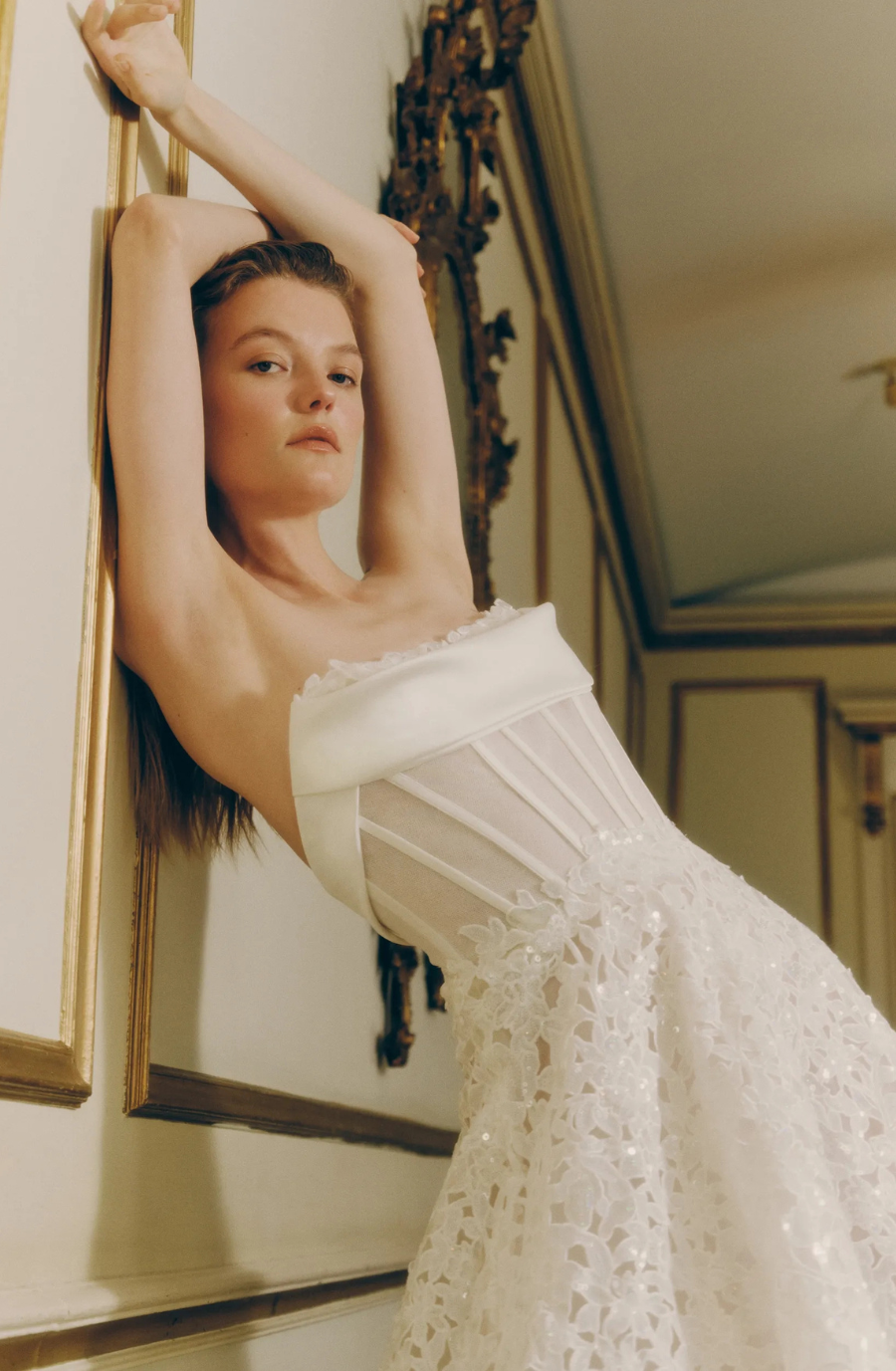 model is wearing a strapless a-line wedding dress by rivini