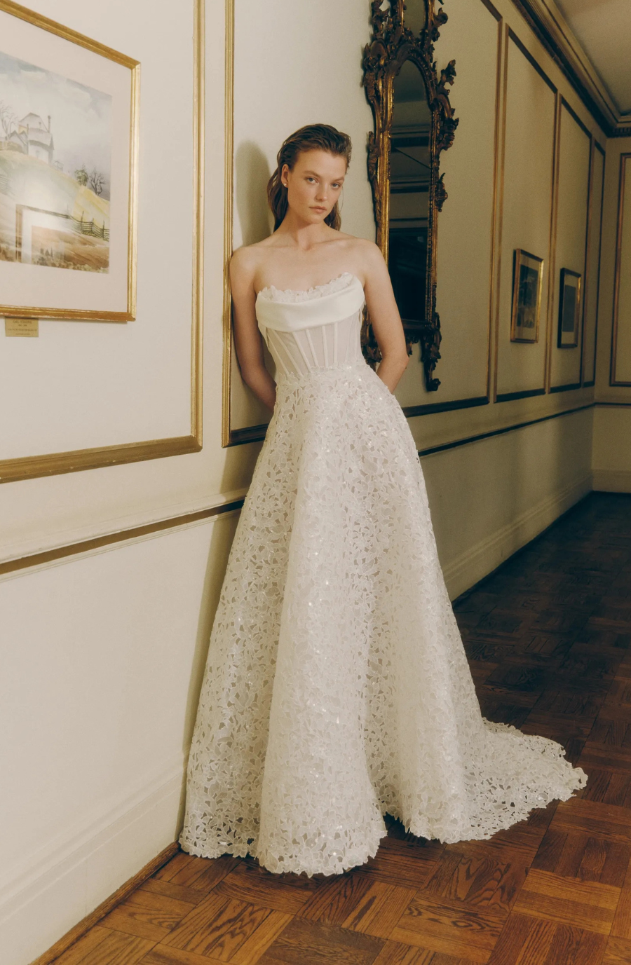 model is wearing a strapless a-line wedding dress by rivini