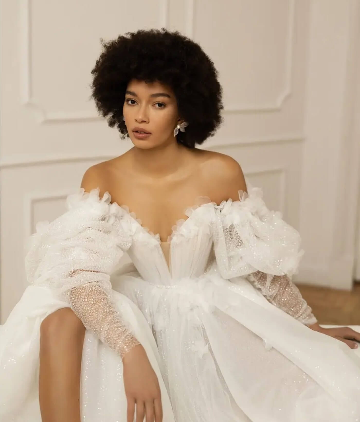 Model wearing a white gown at home