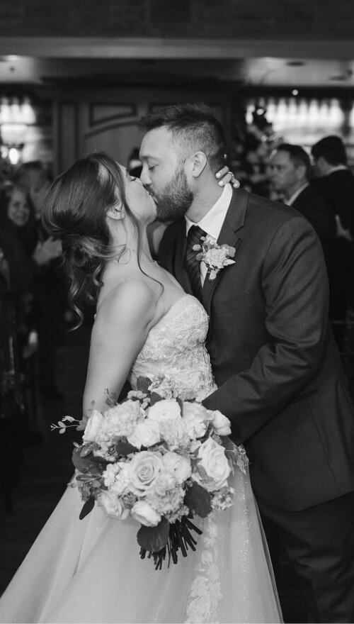 Сouple wearing a white gown and a white suit