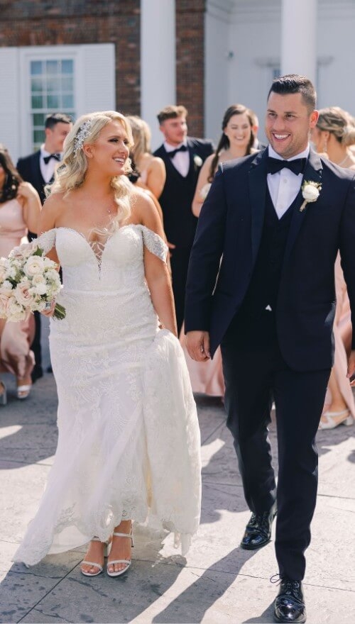 Сouple wearing a white gown and a white suit