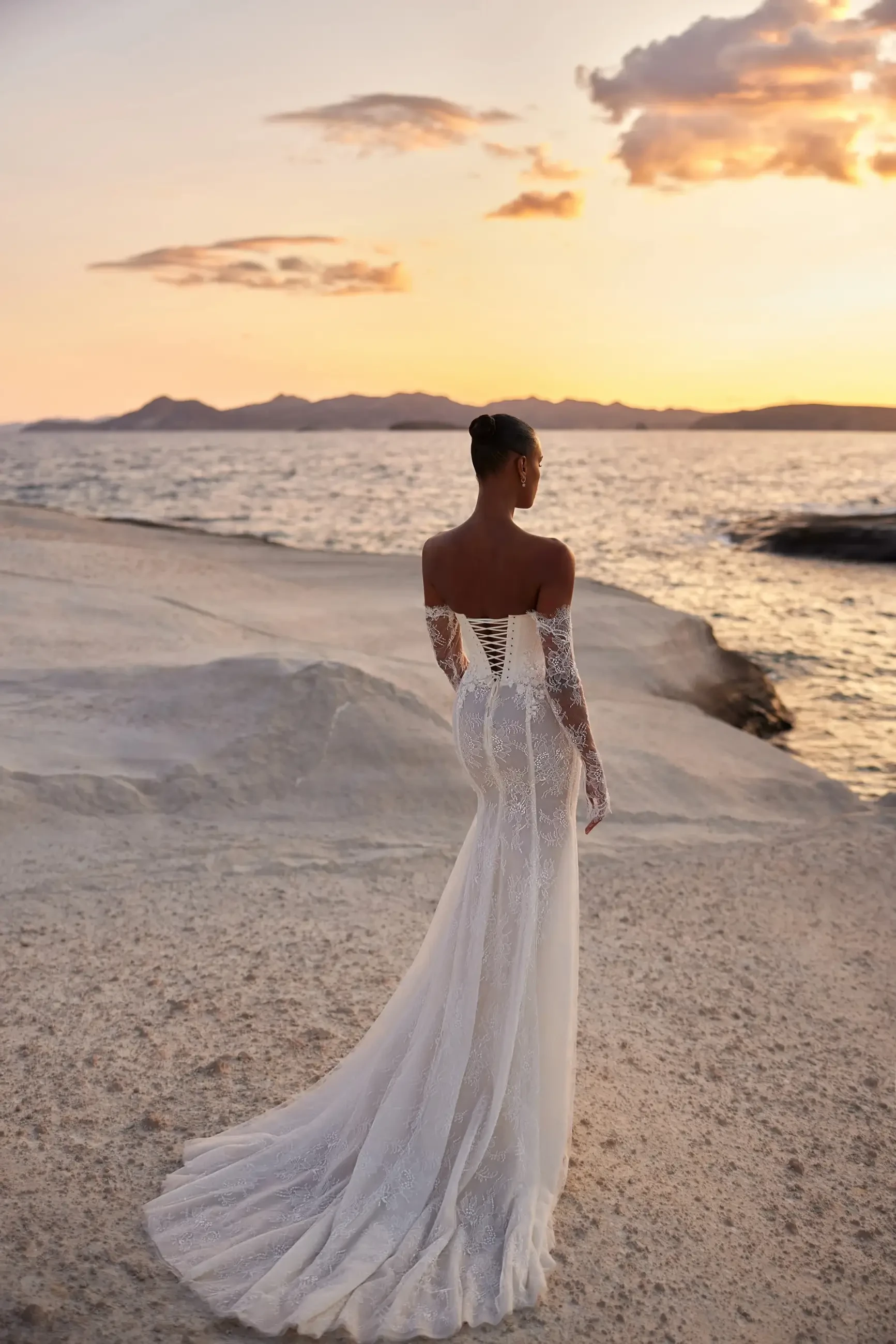 model is wearing a bold bridal gown by eva lendel with a fit and flare silhouette