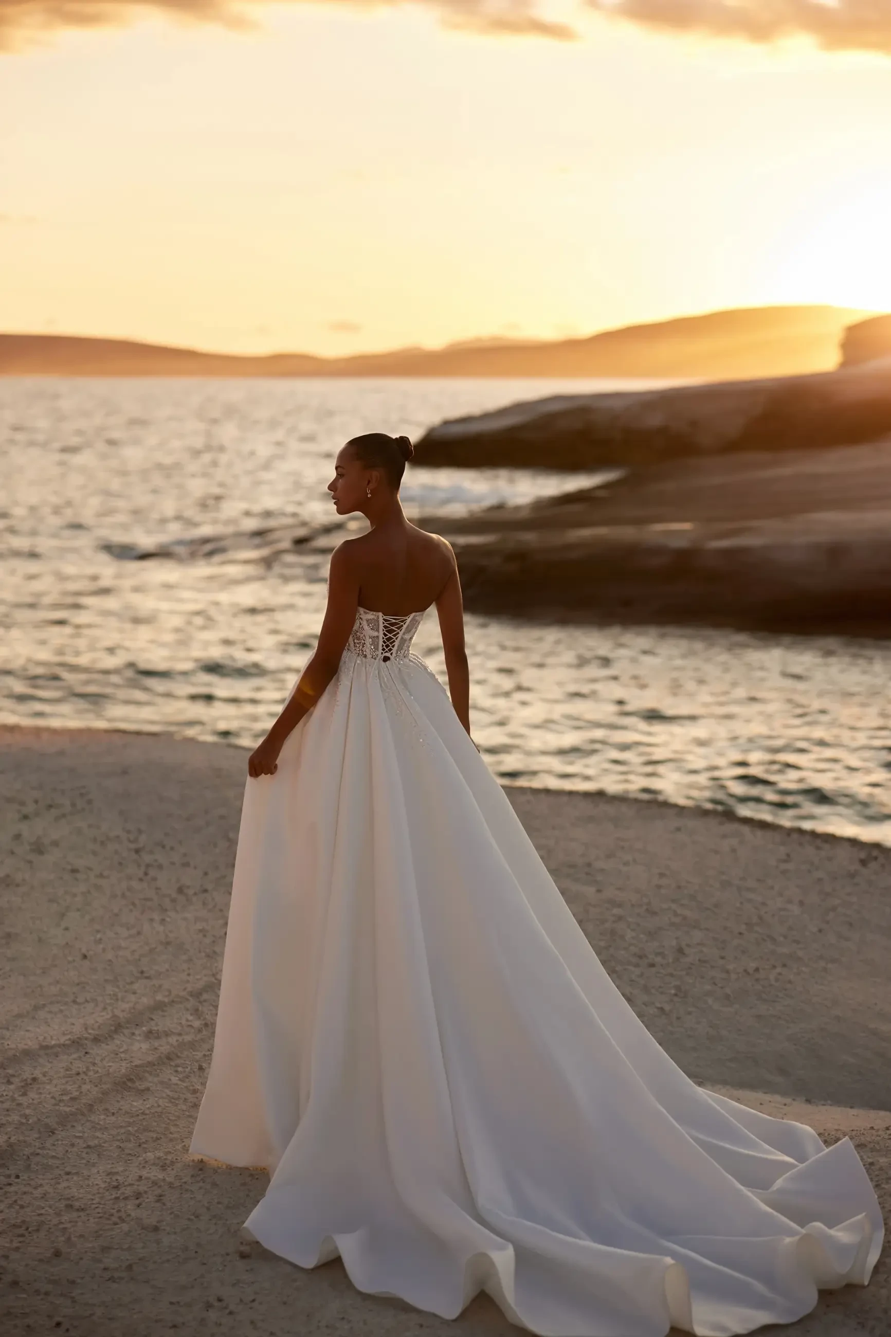 model is wearing a strapless ball gown wedding dress